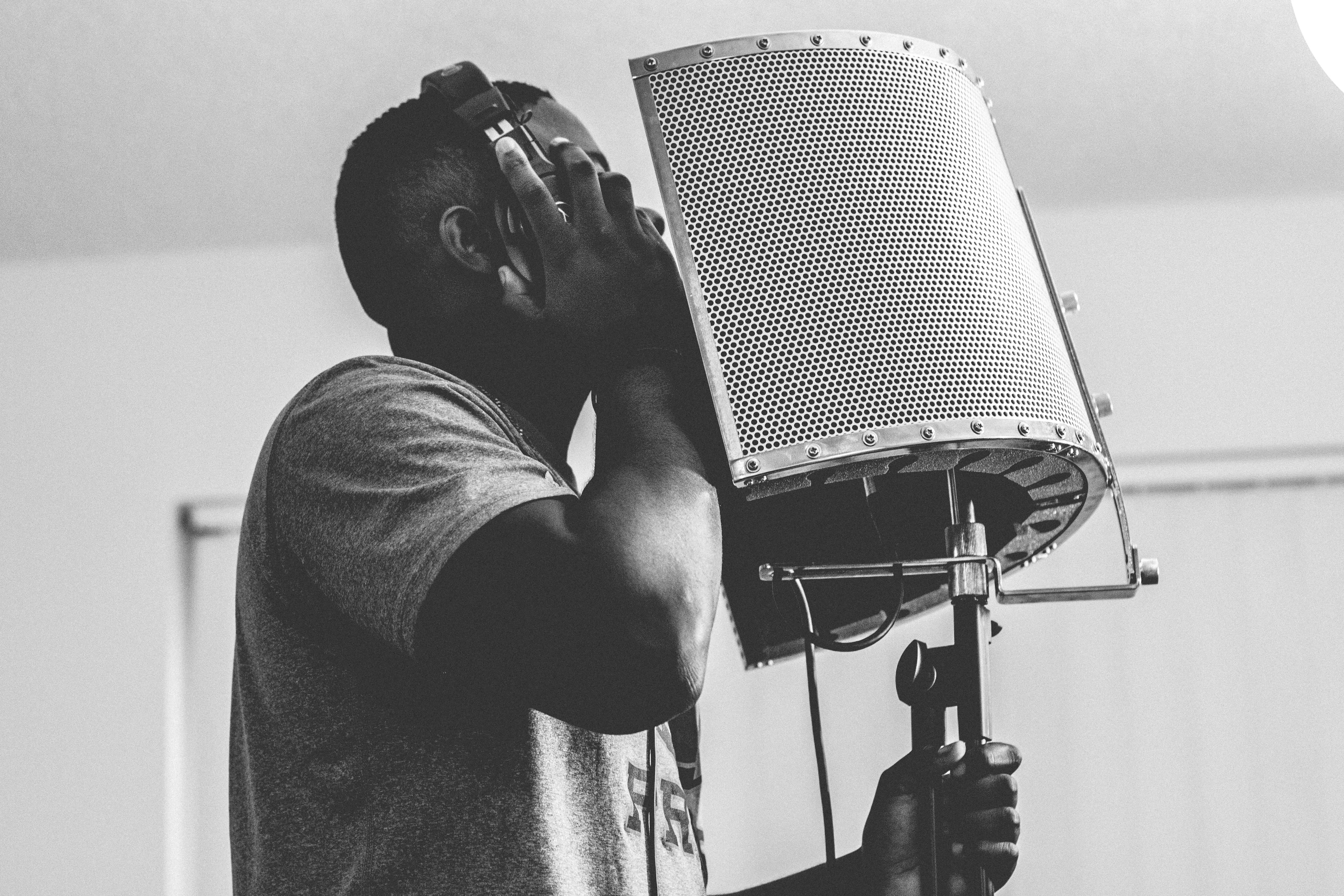 A man singing passionately into a microphone